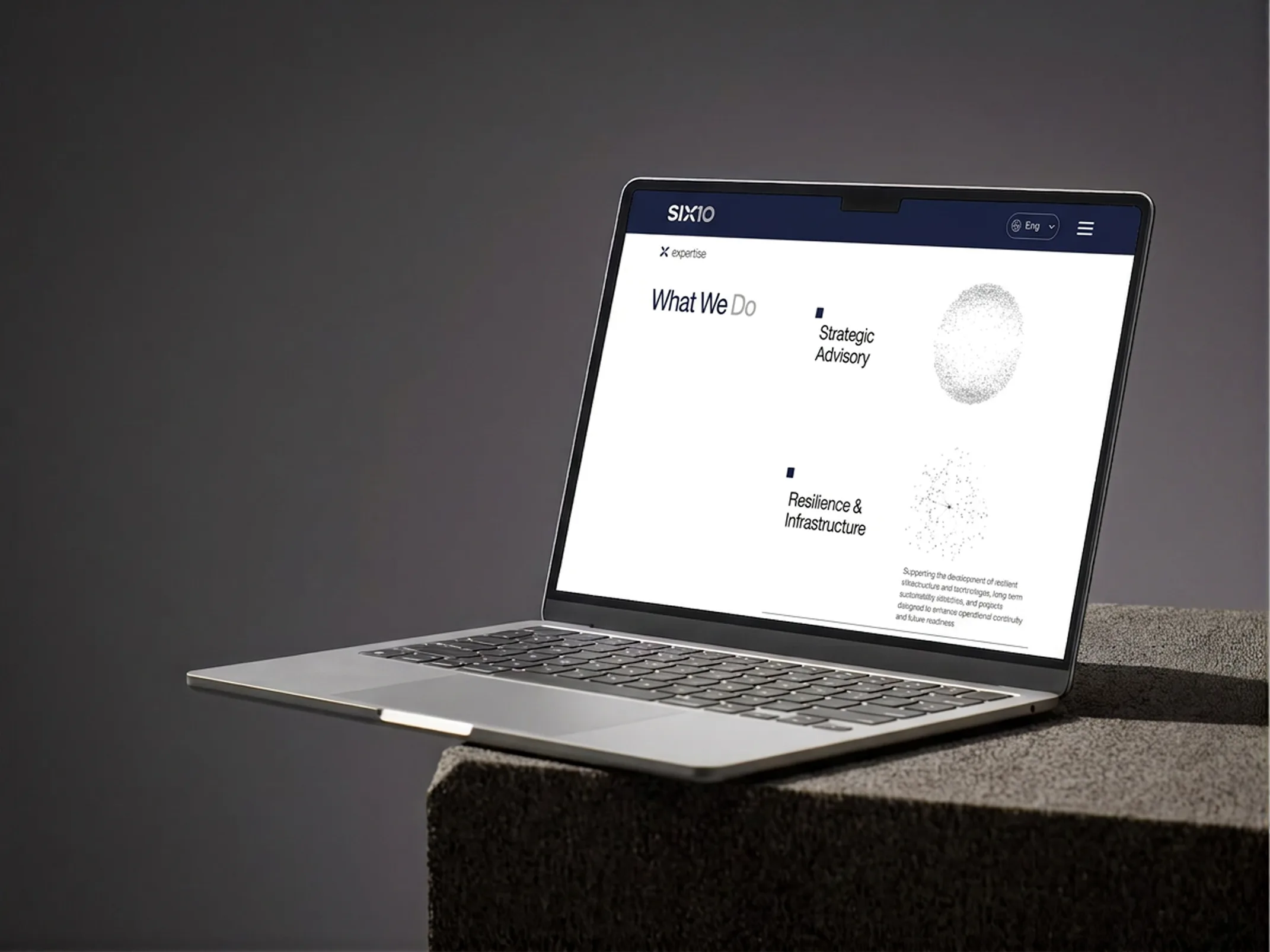 SIX10 — laptop dashboard on stone pedestal